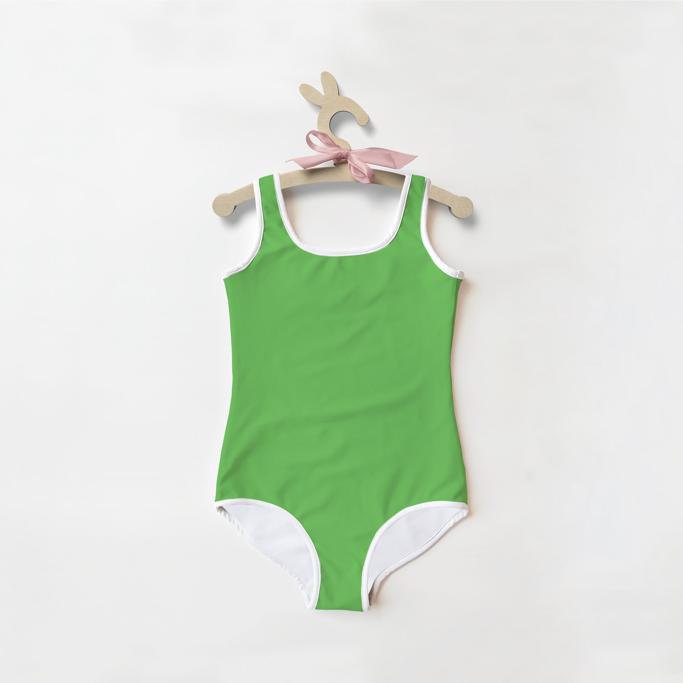 A vibrant green buttery soft one-piece swimsuit for girls with white trim and UPF 50+ sun protection