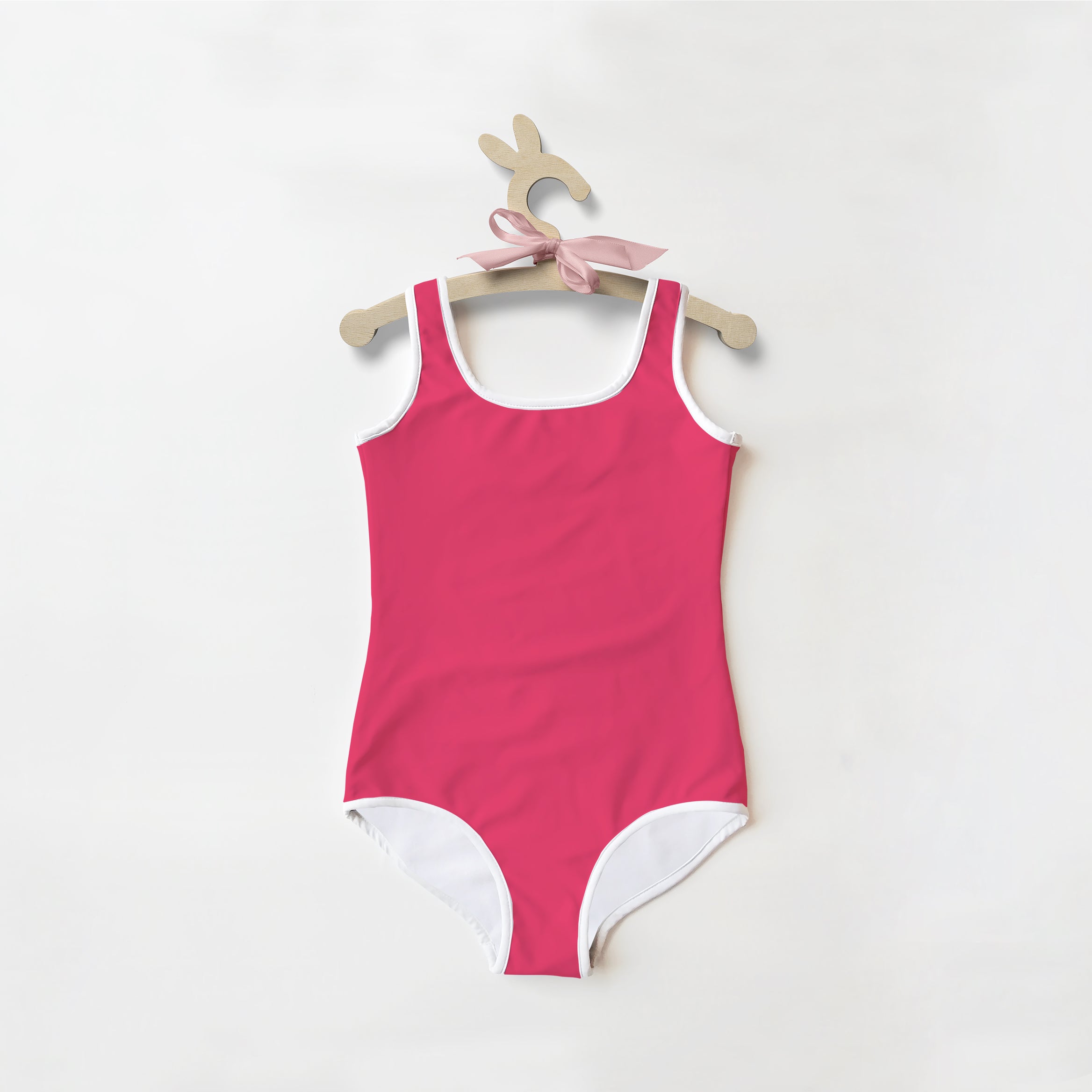 Girls buttery soft rose color one-piece swimsuit with white trim and UPF 50 plus sun protection