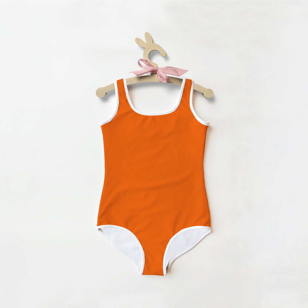 Girls buttery soft orange one-piece swimsuit with white trim and pink ribbon on hanger with UPF 50+ protection