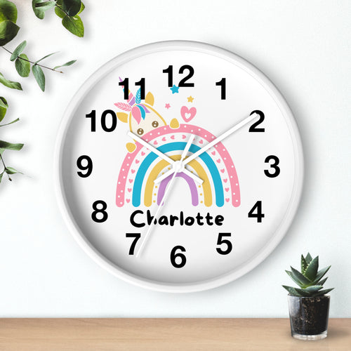A white round silent wood wall clock with pastel rainbow stripes and a custom name charlotte featuring a unicorn design