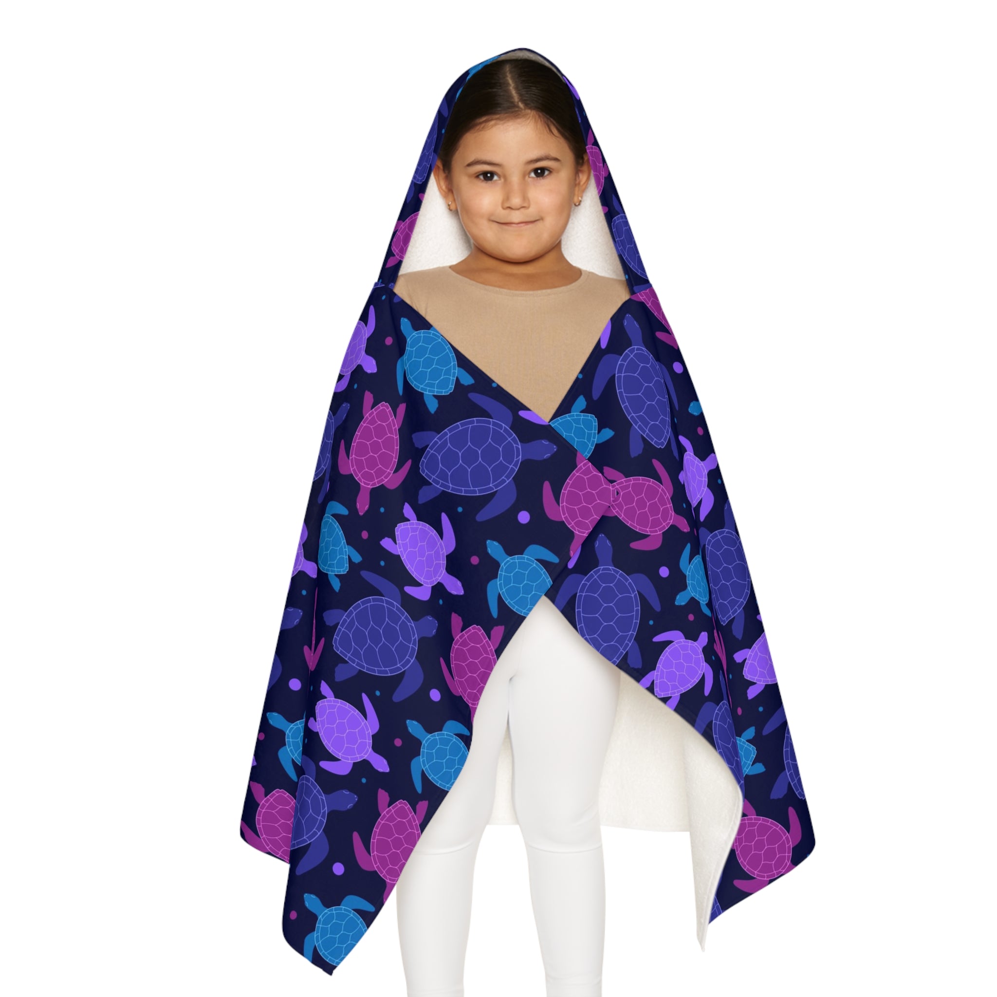 A child wearing a soft navy blue hooded towel with vibrant purple and teal sea turtle patterns perfect for bath time