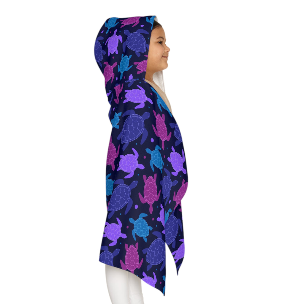 A navy blue kids hooded towel with a vibrant purple pink and teal sea turtle pattern perfect for beach and bath time