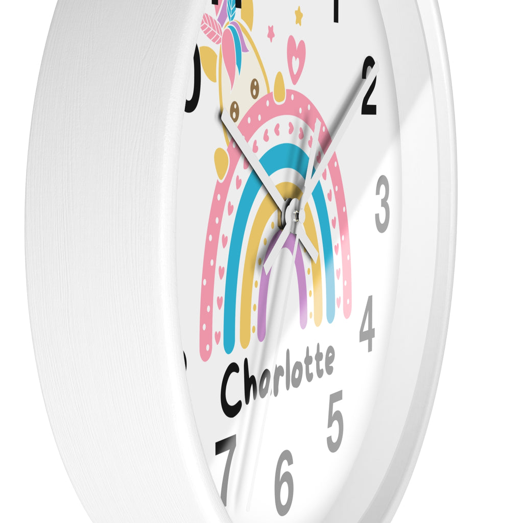 A white round wood wall clock with a colorful unicorn rainbow design and the name charlotte for girls room decor