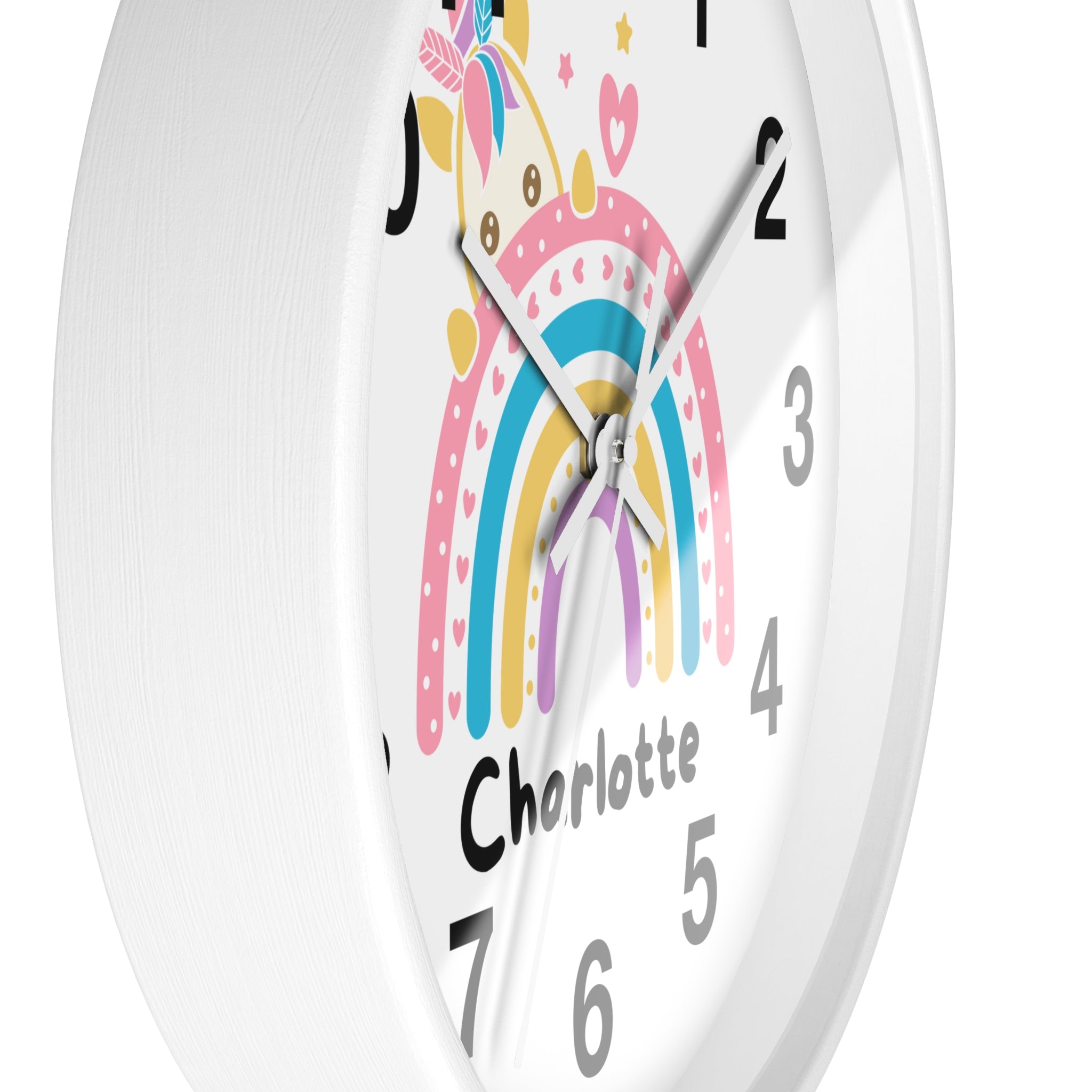 A white round wood wall clock with a colorful unicorn rainbow design and the name charlotte for girls room decor