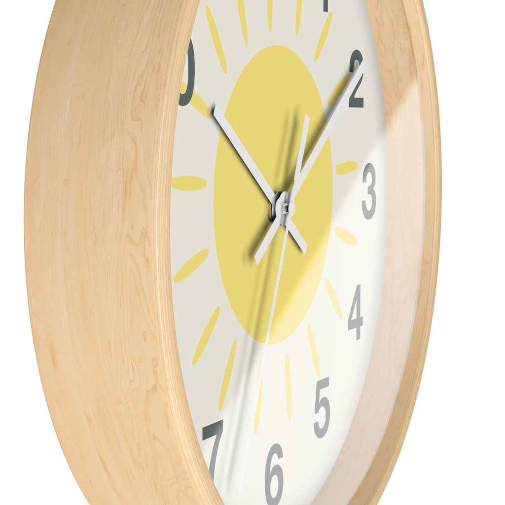 Yellow sun silent wood wall clock with light wood frame and sun-themed face with yellow rays on off-white background