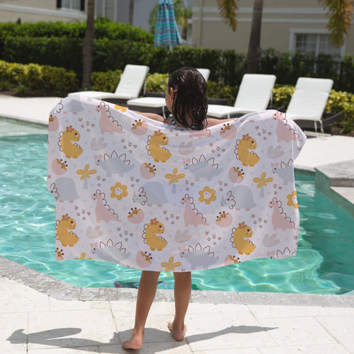 Girls floral dinosaur towel with a white base featuring yellow pink and gray cartoon dinosaurs and flowers