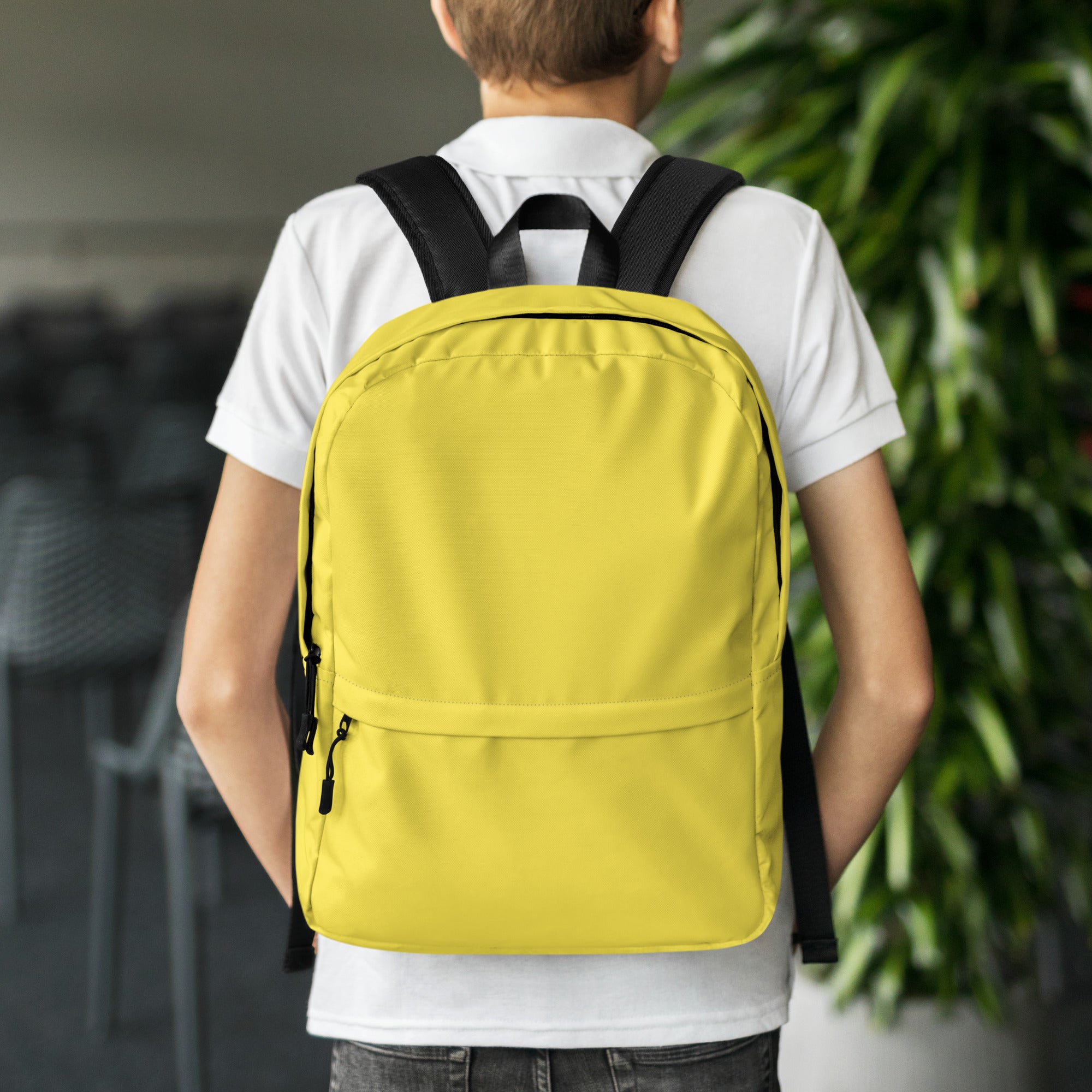 Kids yellow backpack featuring bright yellow fabric with black straps and zipper pulls for durable use