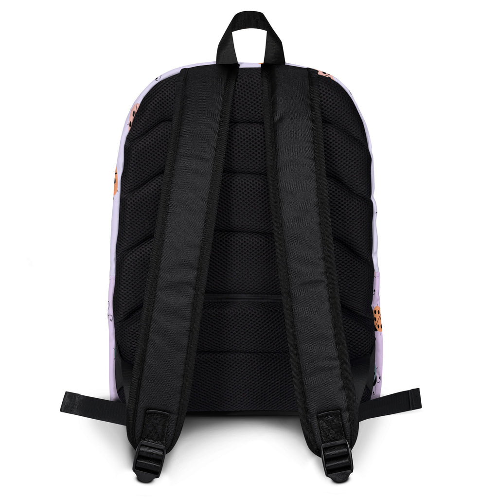 White girls colorful ladybug backpack back view with black mesh straps and soft peach floral pattern on sides