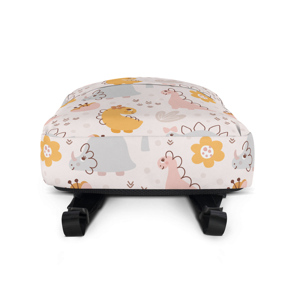 A soft off-white girls floral dinosaur backpack with pastel cartoon dinosaurs and yellow flowers pattern