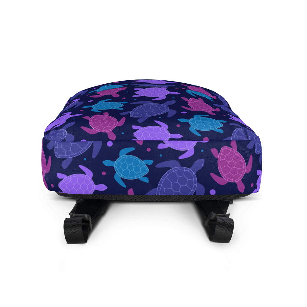 A girls purple sea turtle backpack in navy blue with a vibrant pattern of stylized purple pink and teal sea turtles