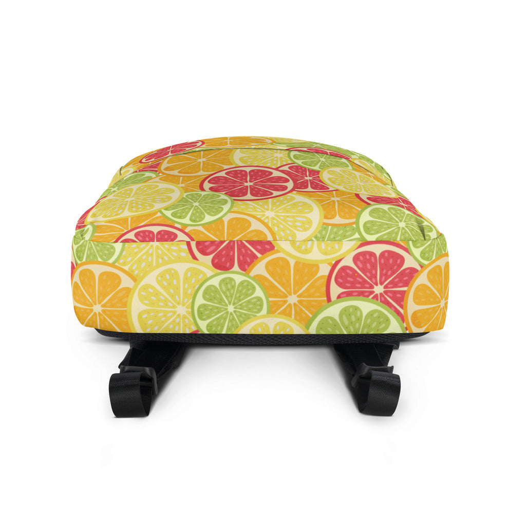 A vibrant kids citrus fruit backpack with playful sliced citrus pattern in bright yellow green and pink hues