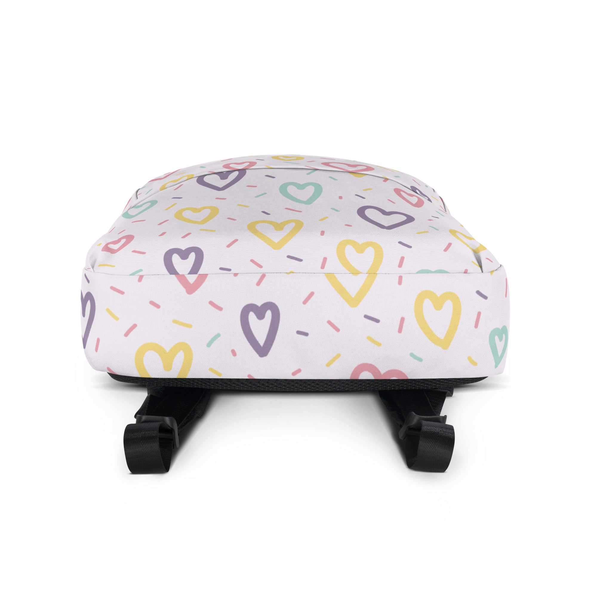 Girls hearts and sprinkles backpack featuring a white base with pastel heart and sprinkle patterns and black straps