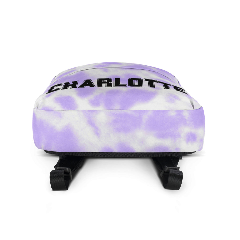 Girls custom name purple and white tie dye backpack with charlotte printed in bold black letters across the top
