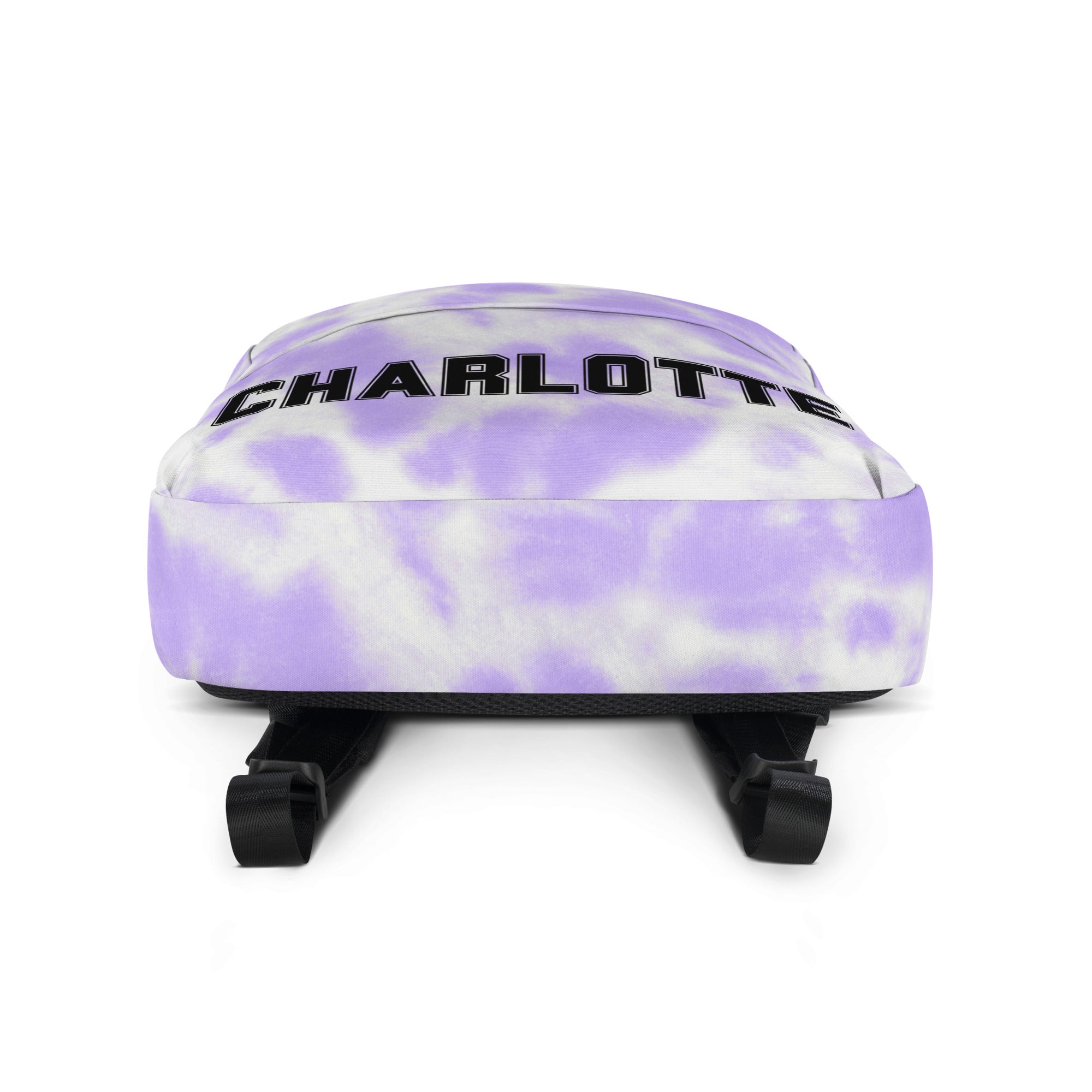 Girls custom name purple and white tie dye backpack with charlotte printed in bold black letters across the top