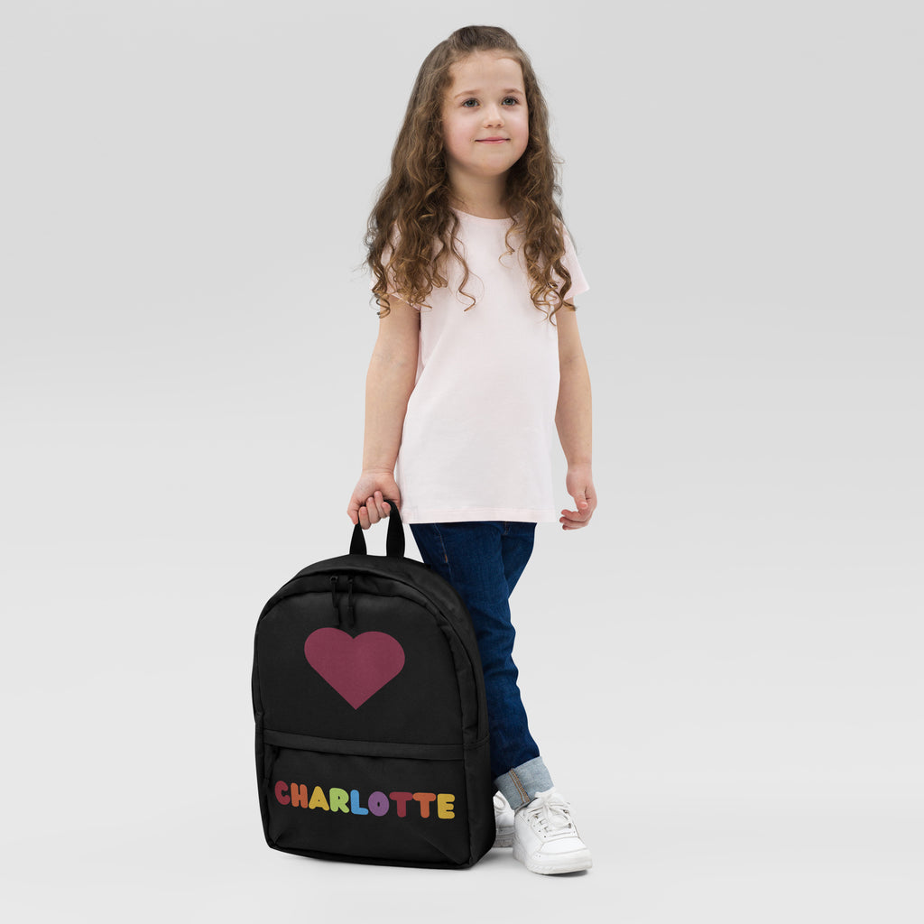 Black girls custom backpack featuring a magenta heart and rainbow-colored charlotte lettering on the front side