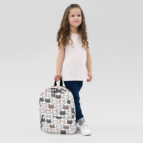 Girls cute cat backpack in white with playful cartoon cat face pattern in gray brown and orange for kids use