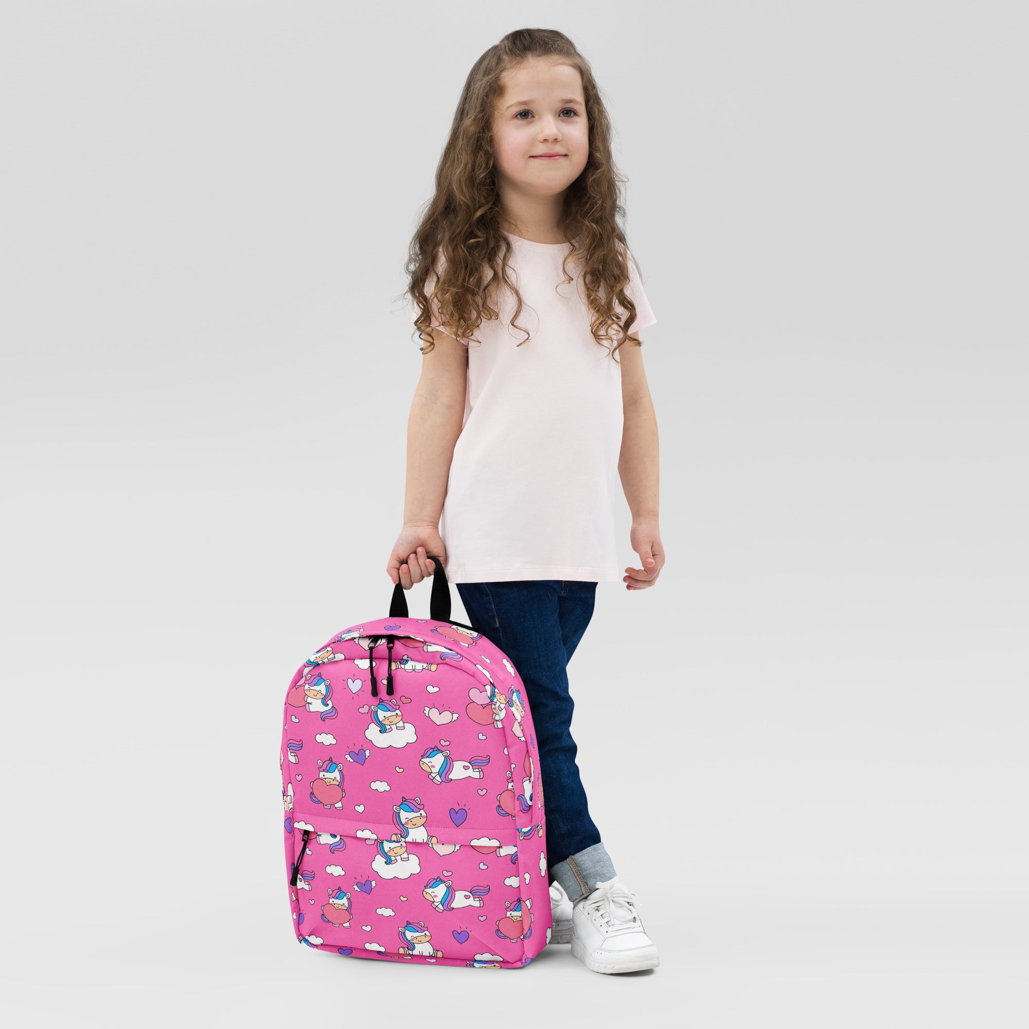 Girls unicorn hearts backpack in pink with playful cartoon unicorns clouds and hearts pattern for kids