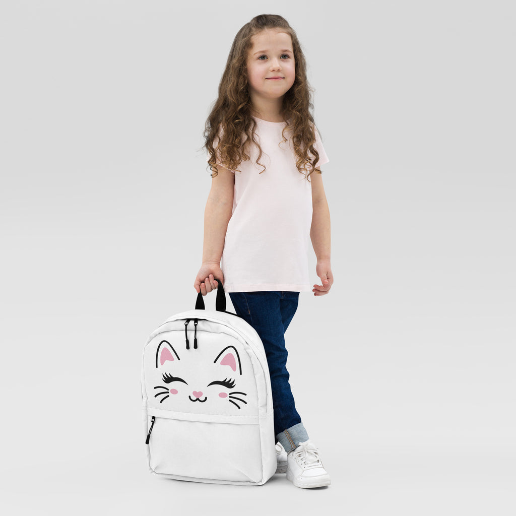 Child holding a white backpack with a cat face design on a light gray background