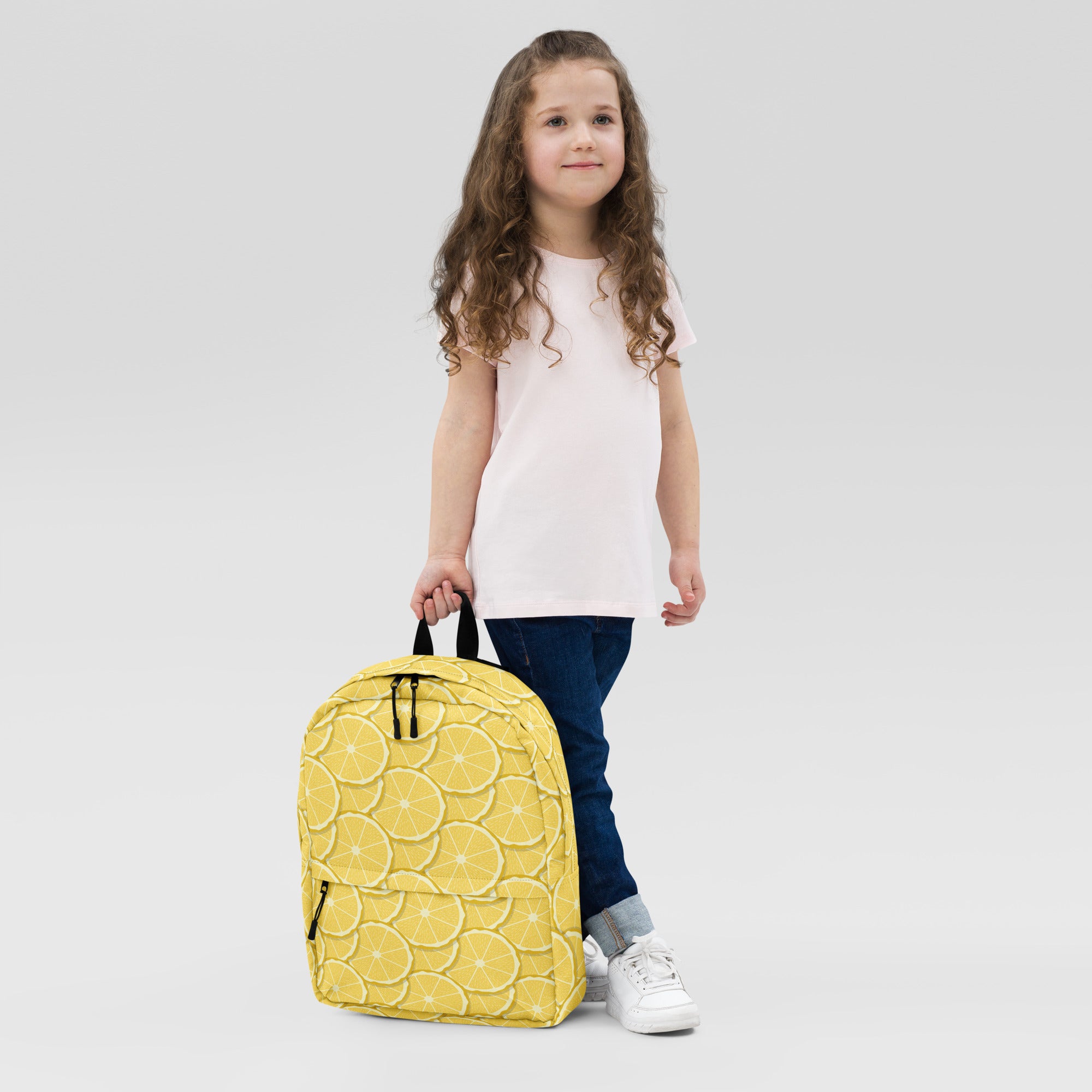 Yellow kids backpack made of durable material with a lemon slice pattern perfect for school or outings