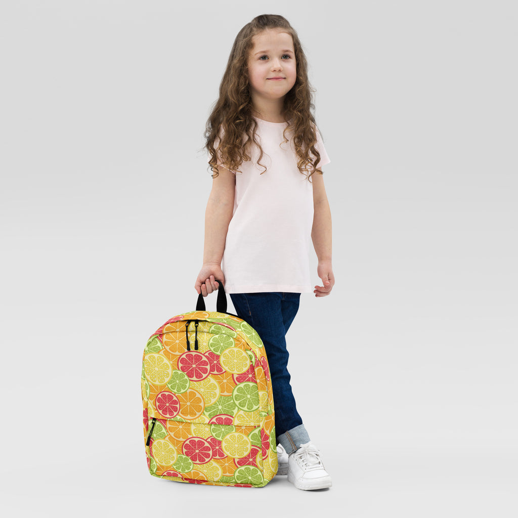 Kids citrus fruit backpack with vibrant lemon lime and grapefruit pattern in bright yellow green and pink hues