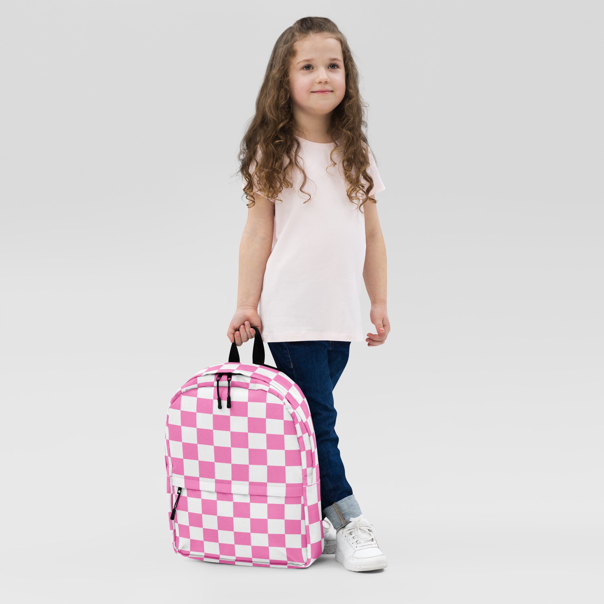 Girls pink checkerboard backpack with pink and white checkered fabric and black zippers for everyday use