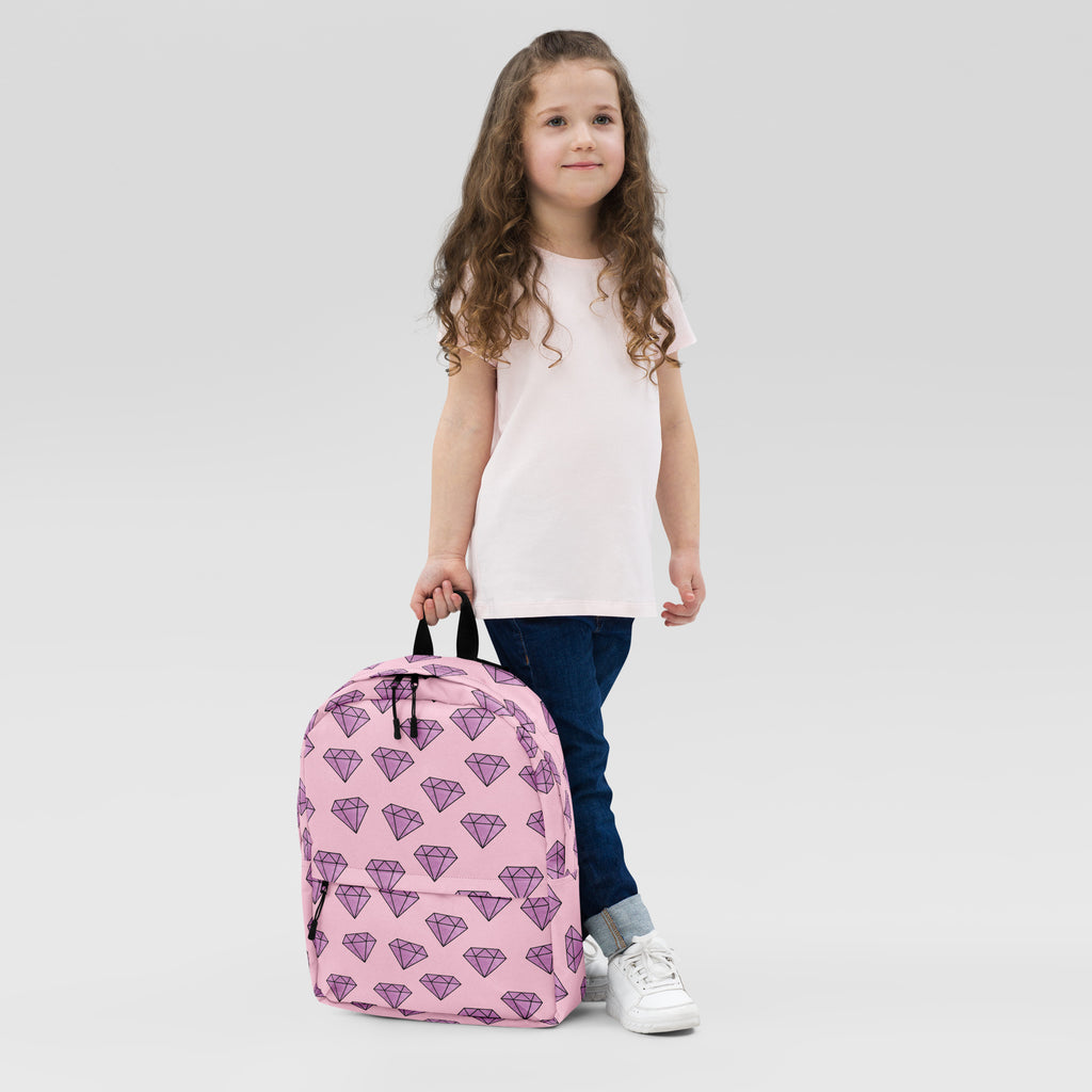 Girls purple diamonds backpack with pink fabric and purple diamond pattern featuring black zippers for school use