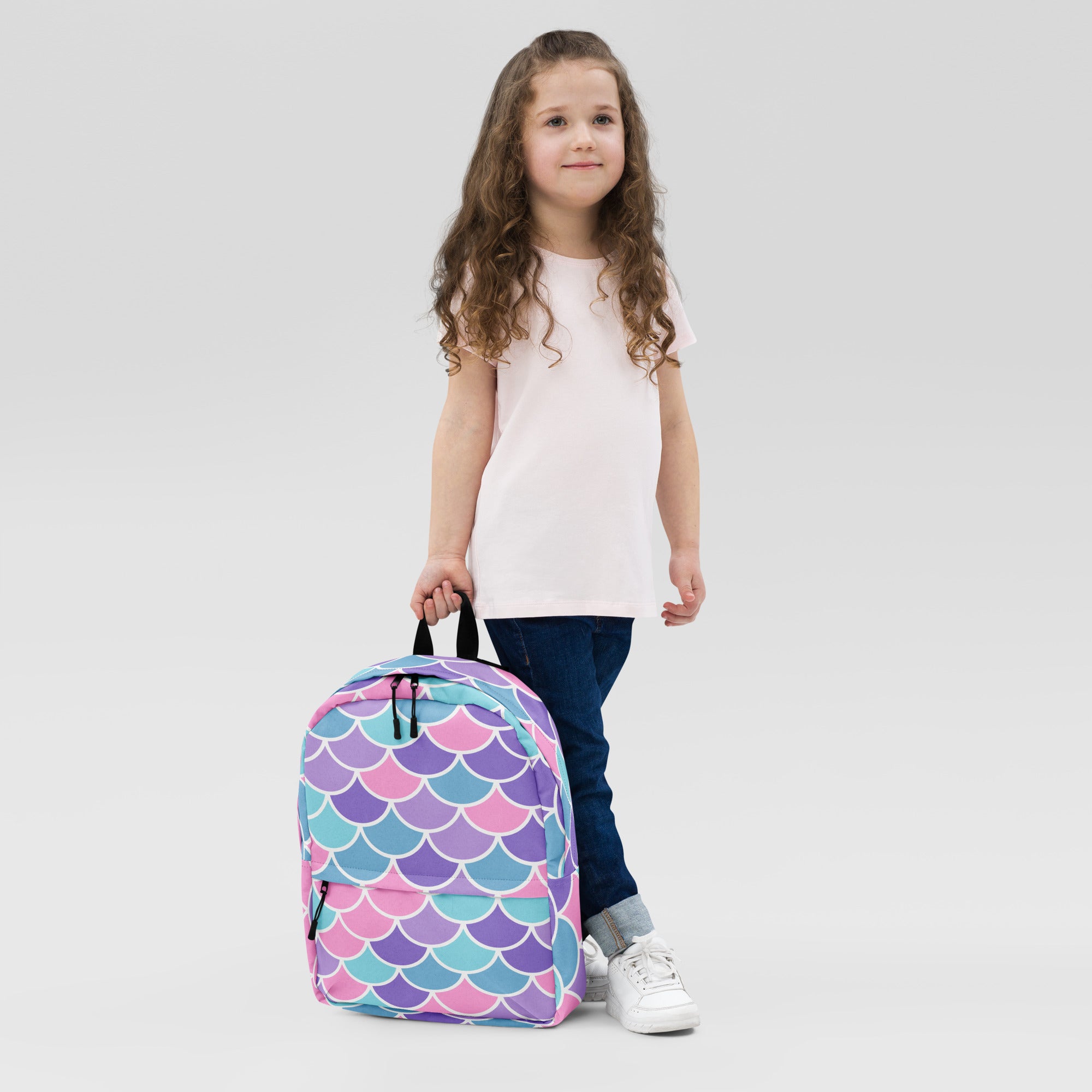 Girls mermaid scale backpack with colorful vibrant pink purple and teal mermaid scale pattern on the front