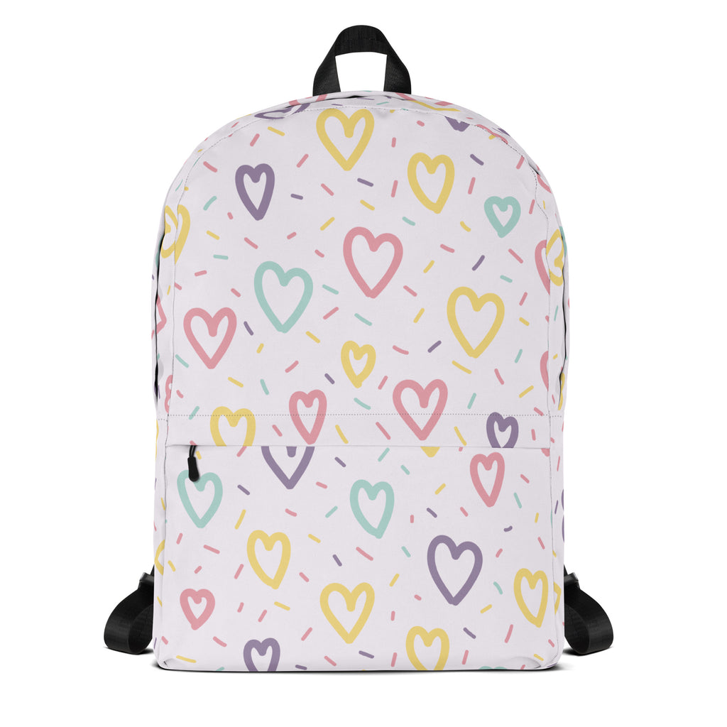 A white girls backpack with pastel hearts and sprinkles pattern in pink yellow mint green and purple