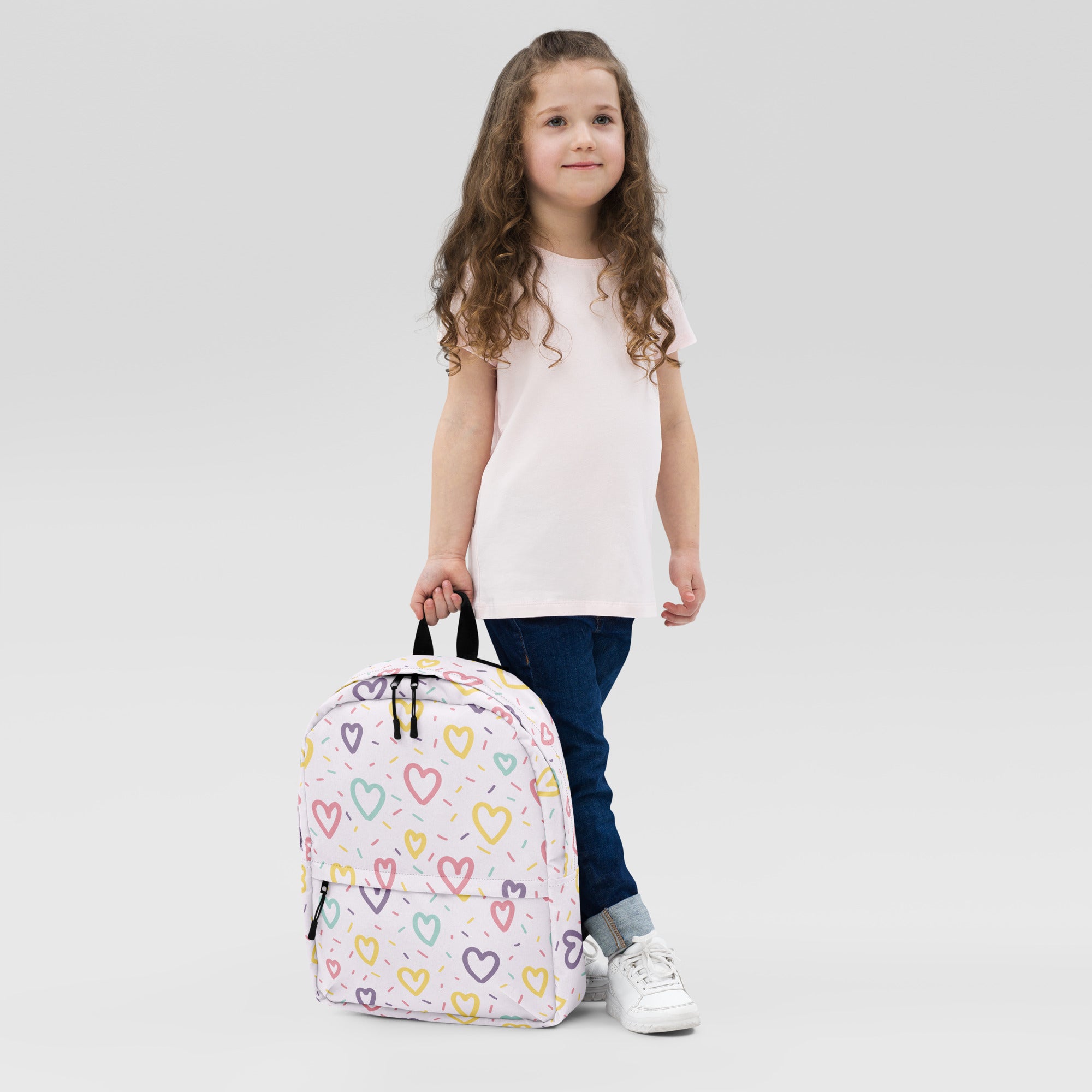 Pastel-colored girls hearts and sprinkles backpack with playful multicolored heart and sprinkle pattern