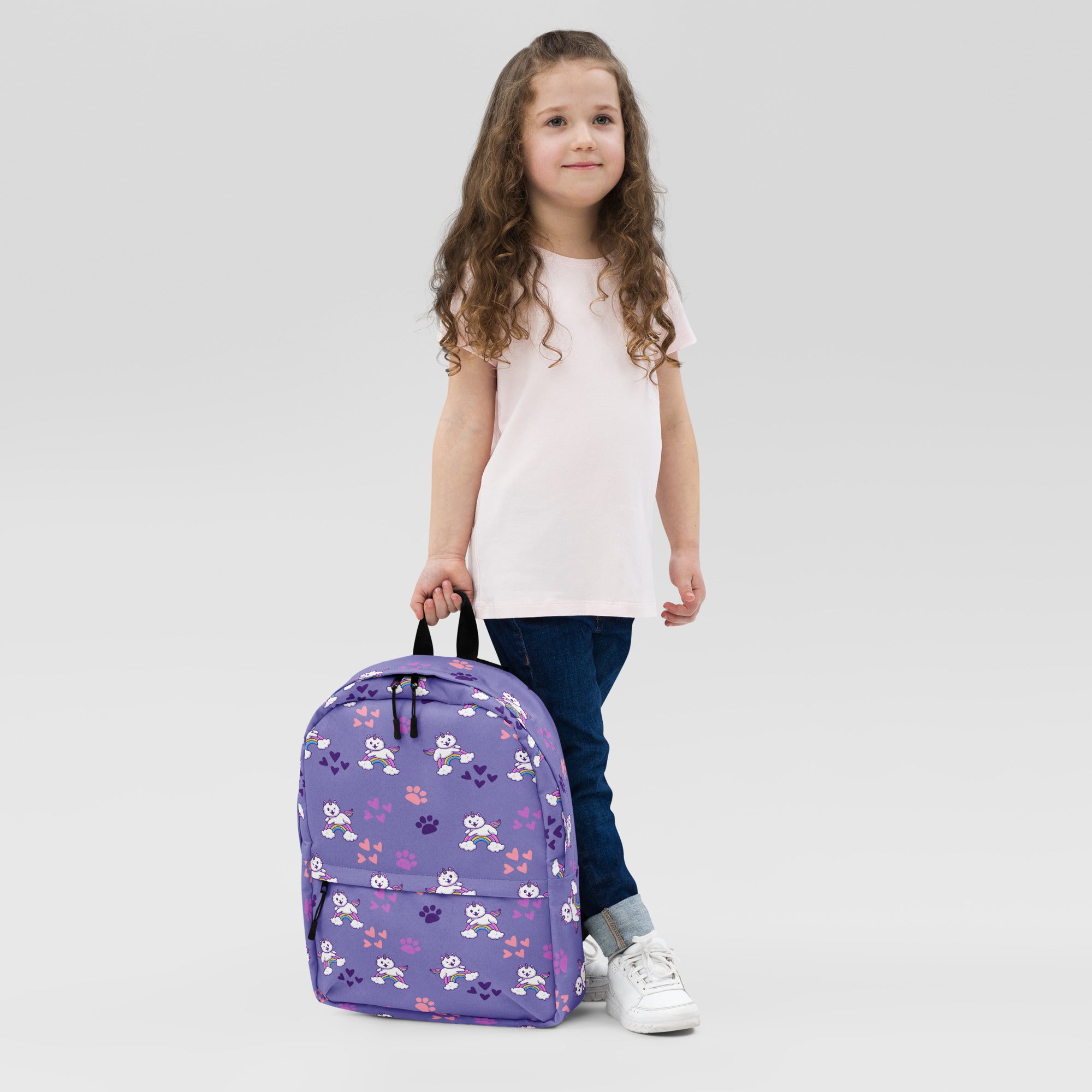 Girls purple rainbow caticorn backpack featuring a playful pattern of white cartoon pandas pink paw prints and hearts