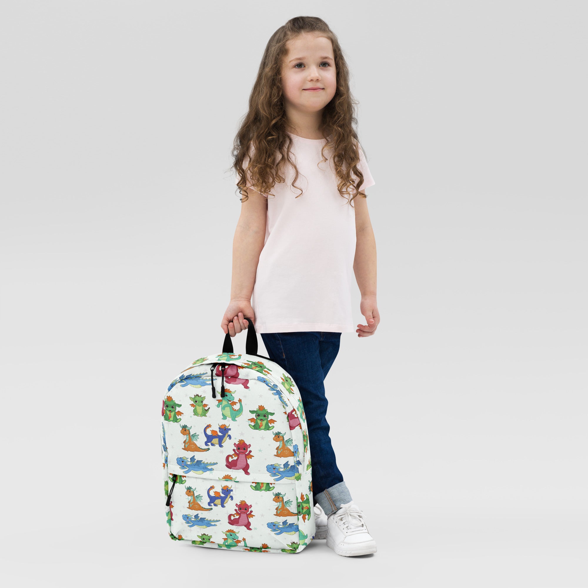 White kids cartoon dragons backpack with colorful playful dragon pattern for school and casual use