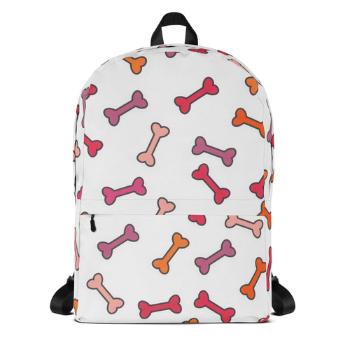 White girls colorful dog bone backpack with playful multicolored cartoon bones in pink orange and purple pattern