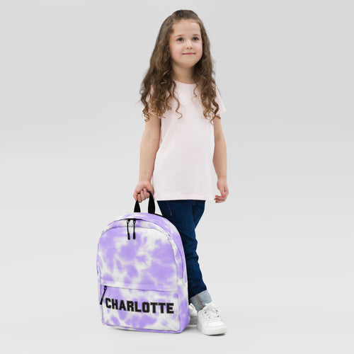 Girls custom name purple tie dye backpack with black zipper pulls and the name Charlotte printed in bold letters