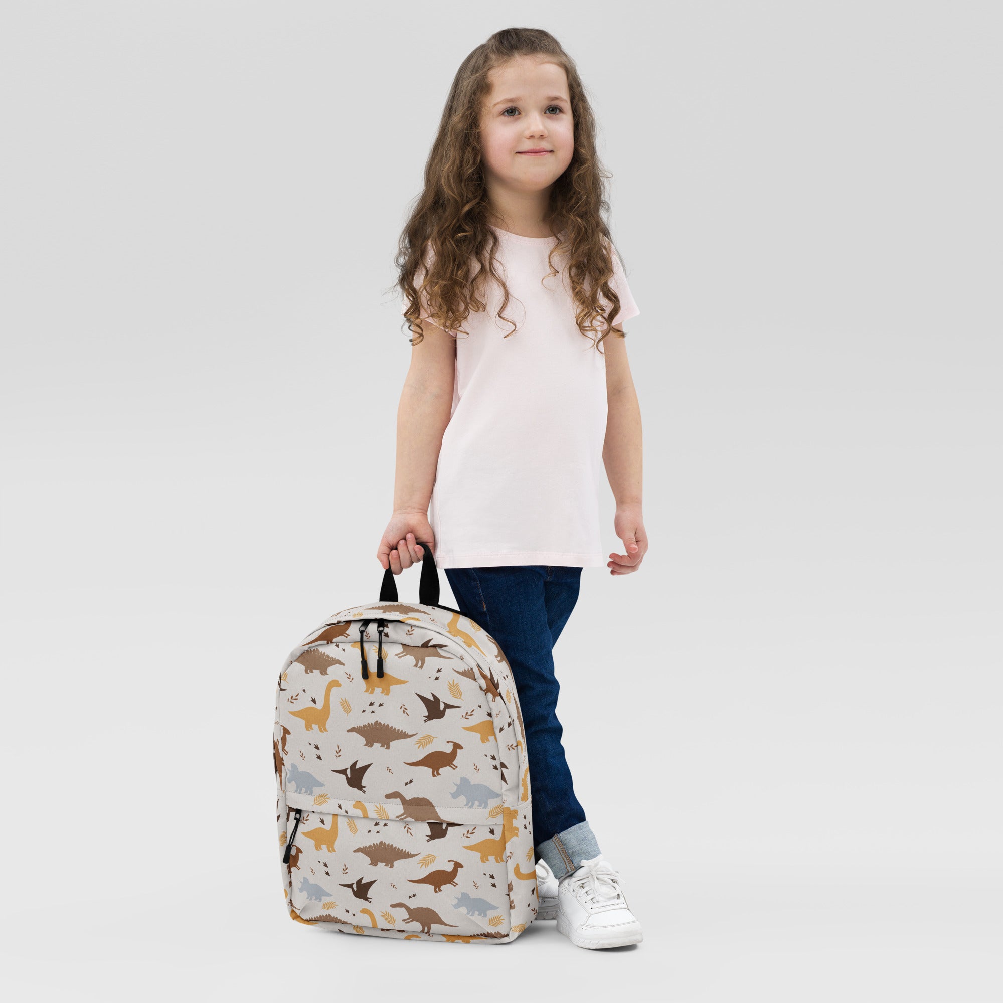 Beige kids dinosaur print backpack with playful brown tan and gray dinosaur pattern for school and outings