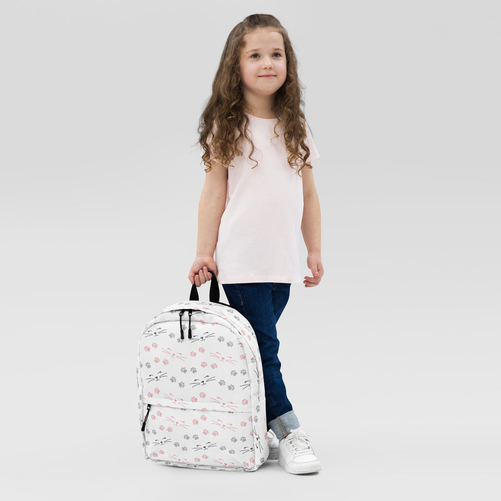 Girls paw print cat backpack white with playful pink and gray cat faces and paw prints black zippers and handles