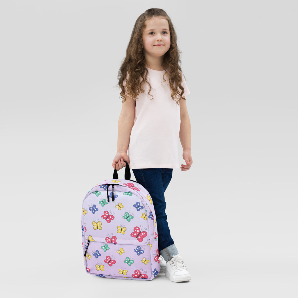 A lavender girls colorful butterfly backpack with a playful pattern of pink yellow green and blue butterflies