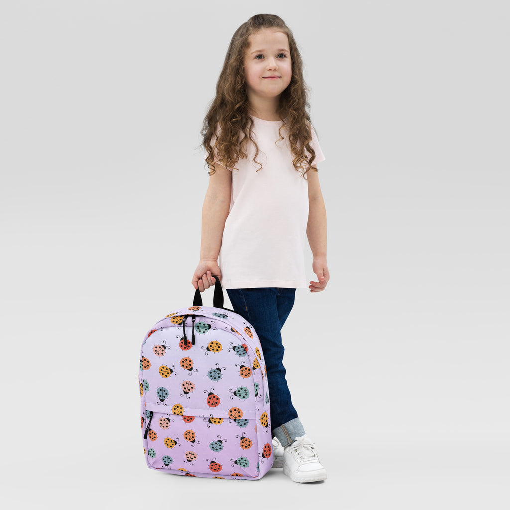 Girls colorful ladybug backpack in lavender featuring a playful pattern of orange green and black ladybugs