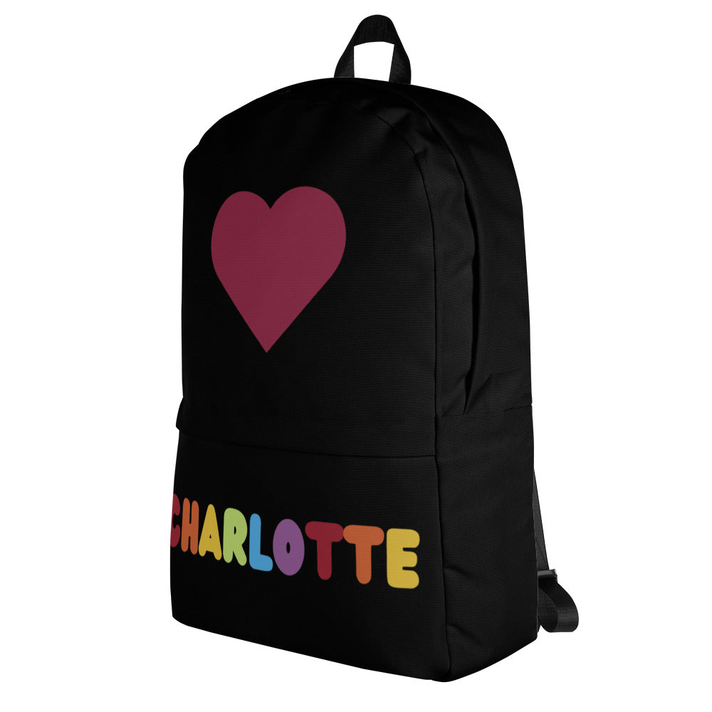 Black girls custom backpack featuring a maroon heart and rainbow-colored name charlotte on the front side