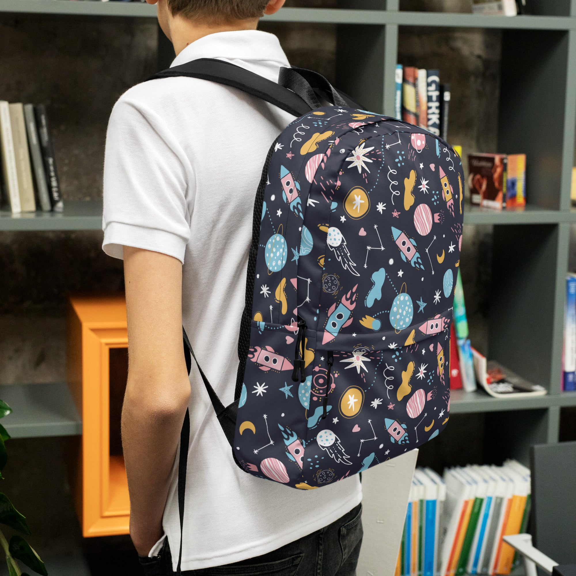 A navy blue kids outer space backpack with colorful pastel rockets planets and stars space-themed pattern