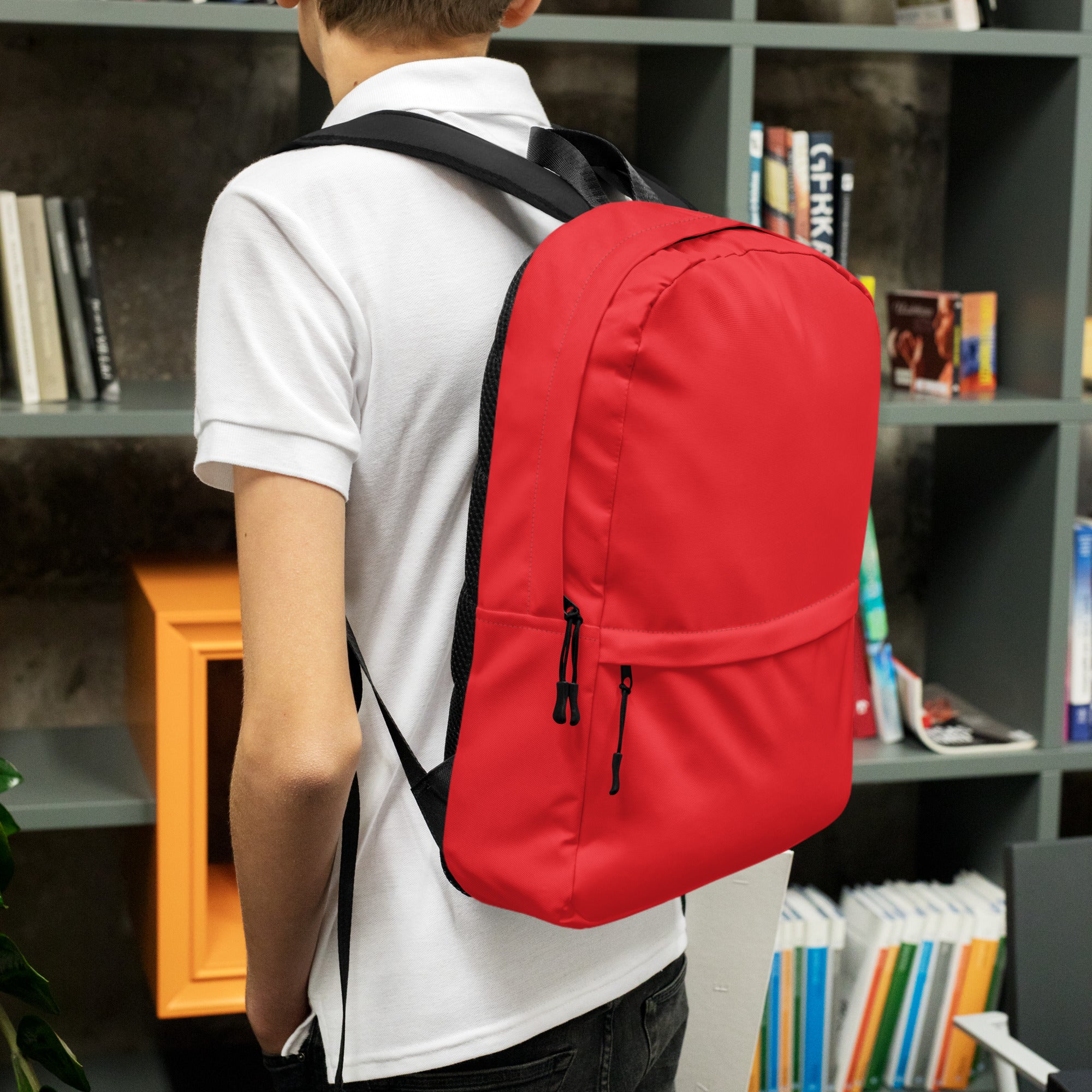 Kids red backpack made of nylon with black straps and zipper pulls shown from the front side
