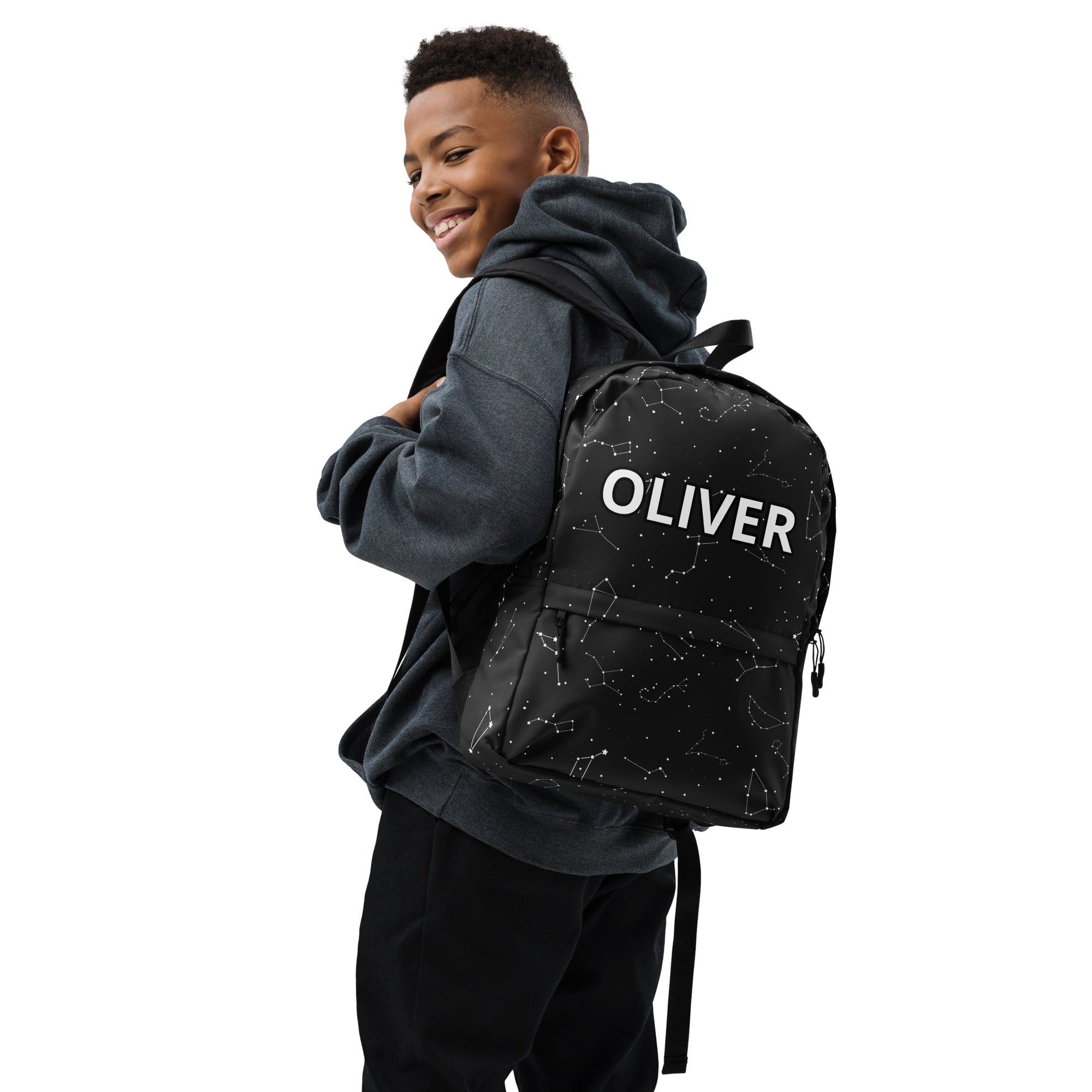 Black kids backpack with white constellation pattern and oliver printed in bold uppercase letters on the front