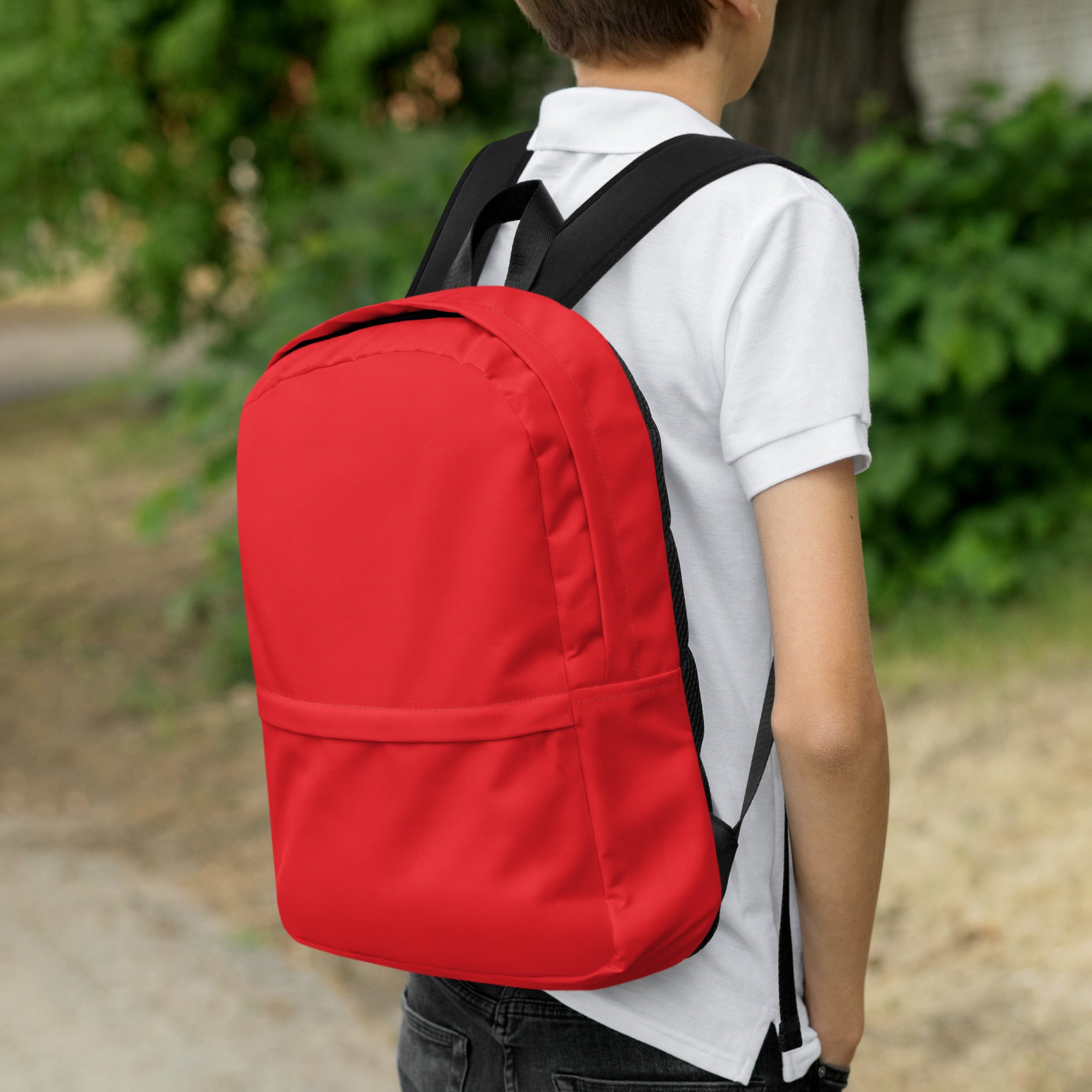 Kids red backpack with black straps featuring a simple minimalist design for everyday use