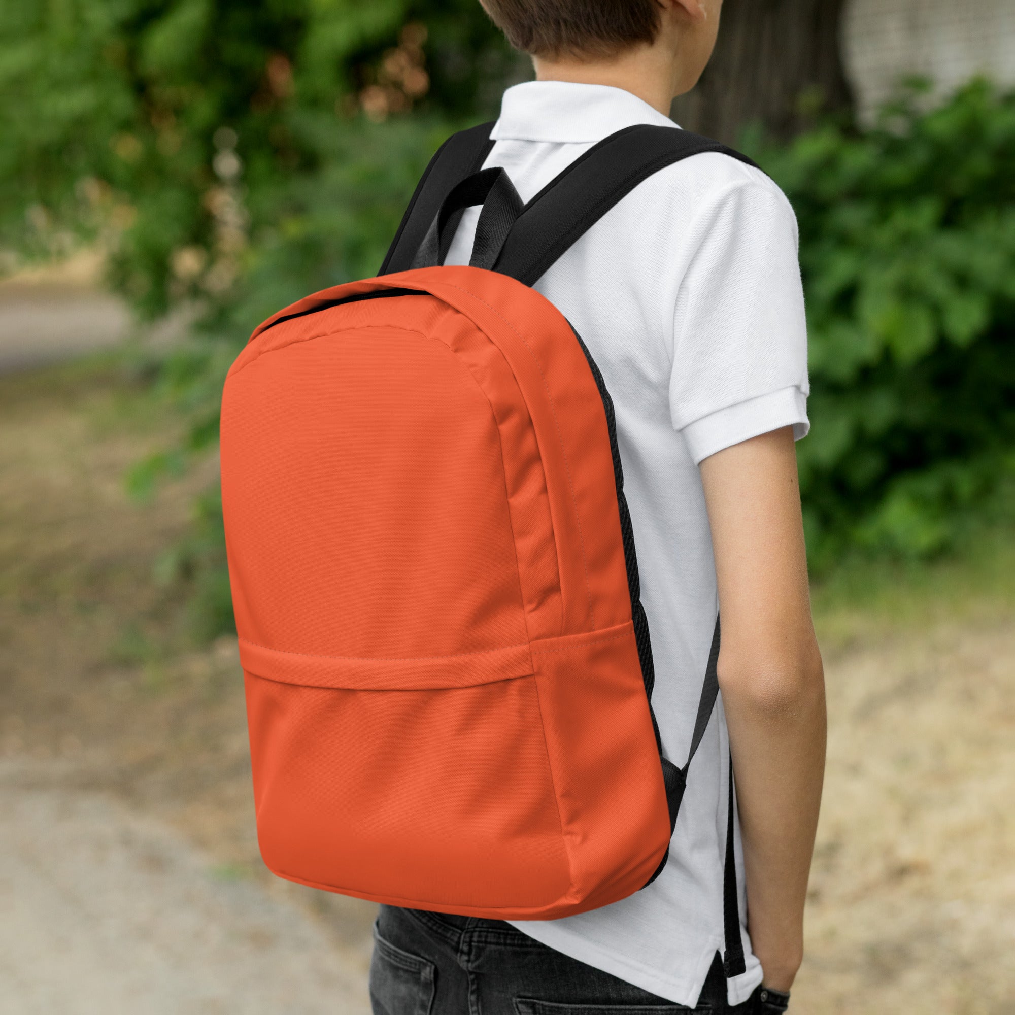 Kids orange backpack with black straps and minimalist design shown from the back side