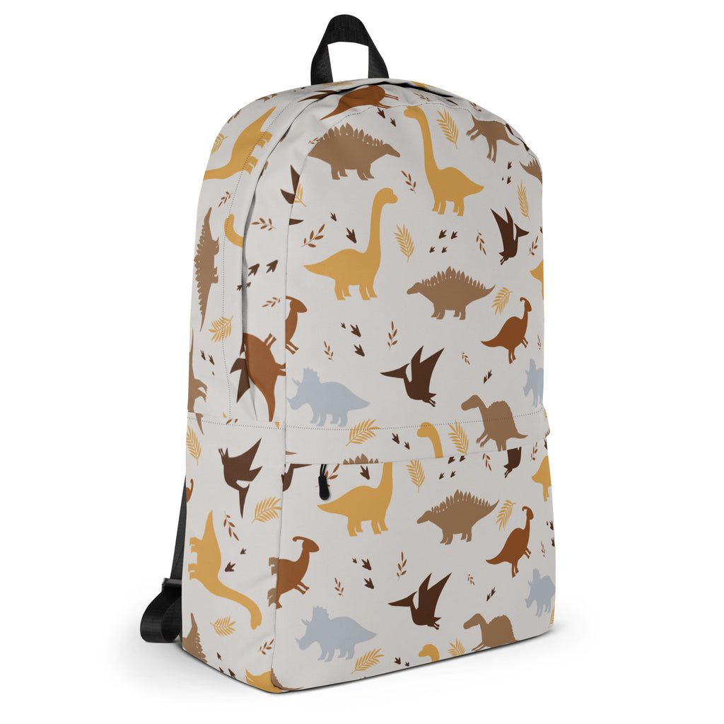 White kids dinosaur print backpack with brown yellow and gray dinosaur silhouettes and leafy accents