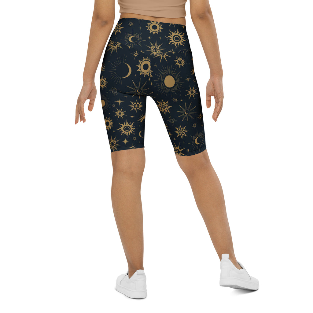Women’s dark blue high waisted biker shorts with vibrant gold celestial sun moon and stars pattern moisture wicking