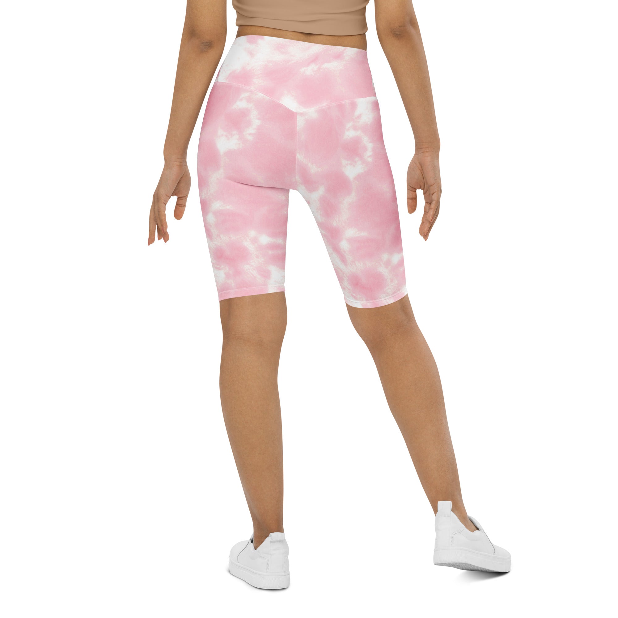 Women’s pink and white tie-dye high waisted bike shorts with moisture wicking active fit fabric shown from the back