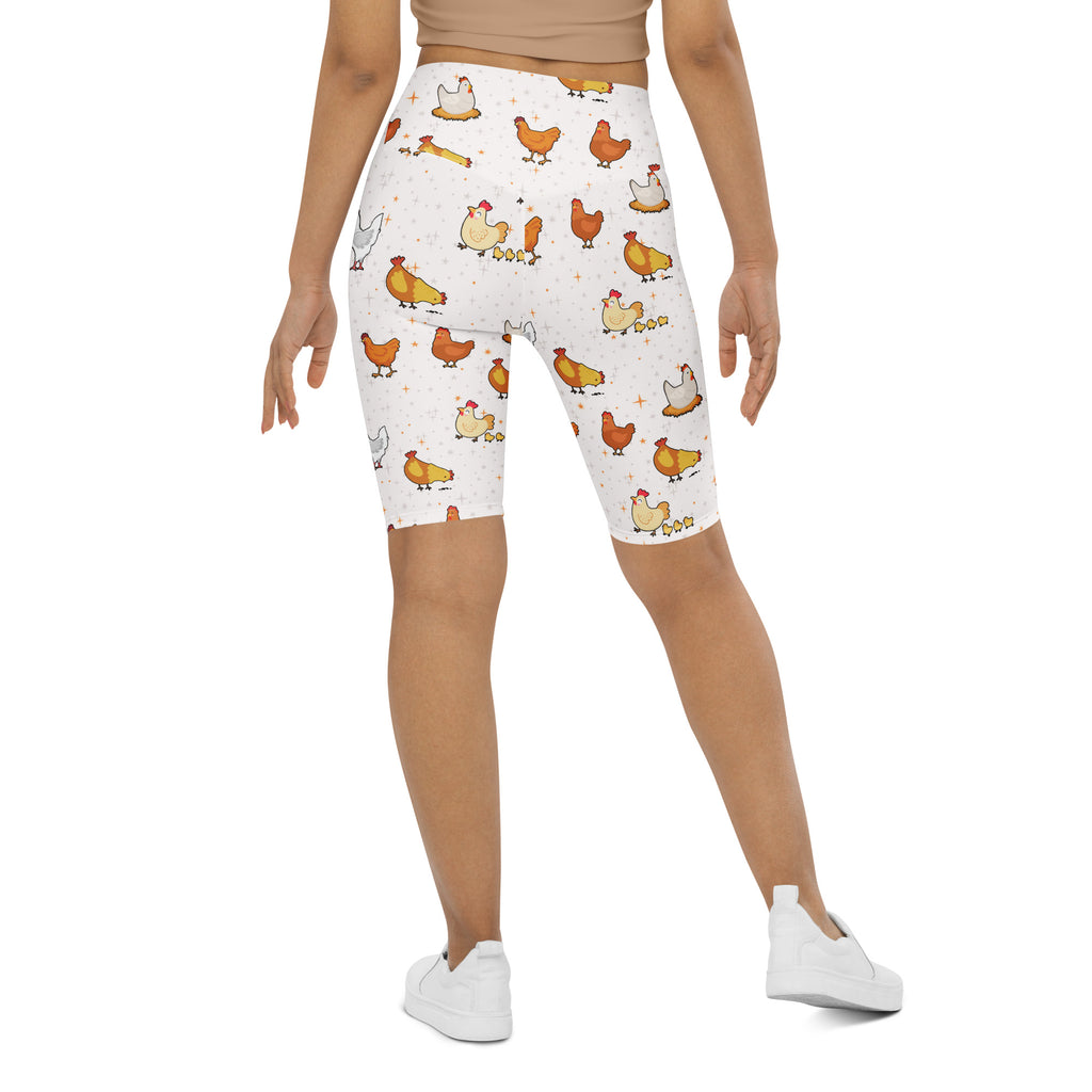 Women’s white high waisted biker shorts with moisture wicking fabric featuring colorful cartoon chicken patterns