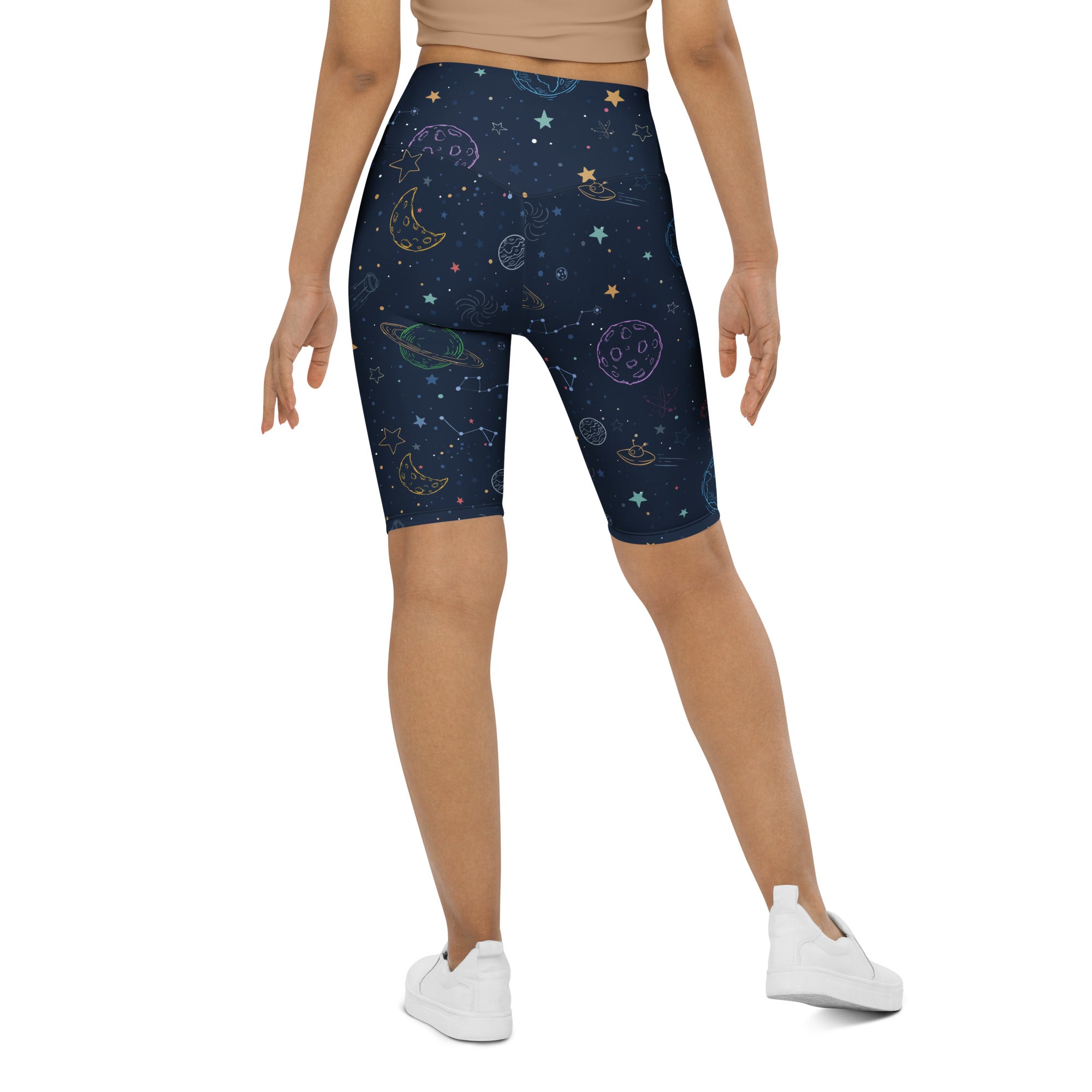 Dark blue women’s high waisted biker shorts with pastel space-themed planets and stars moisture wicking active fit