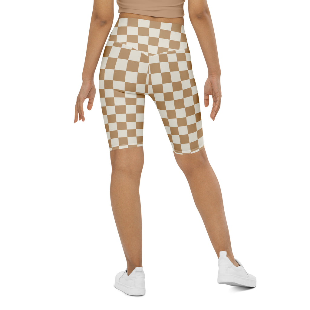 Women’s beige and white checkered high waisted biker shorts with moisture wicking active fit shown from front view