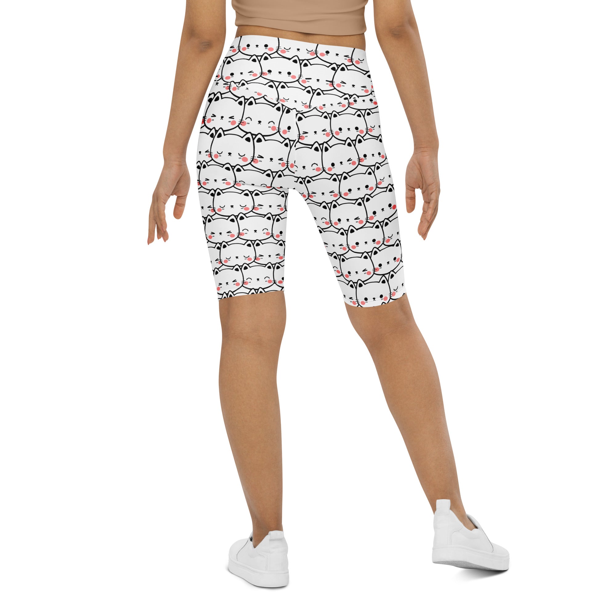 White women’s high waisted bike shorts with moisture wicking fabric and black outlined cartoon cat print with pink cheeks